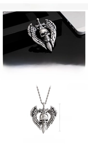 Detailed view of Gothic skull pendant with wings and sword made of matte stainless steel