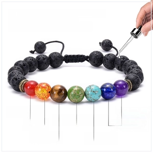 Detail of applying essential oils to lava stone and chakra beads on a yoga bracelet
