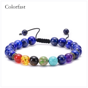 Detail of 7 chakra natural stones on a lapis lazuli beaded bracelet with adjustable cord