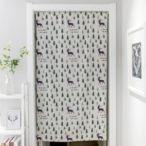 Close-up of linen door curtain with reindeer print and See the World text