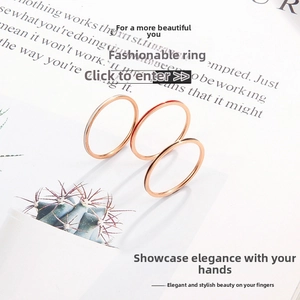 Detailed view of three ultra-thin 1mm rose gold enamel rings on a magazine background
