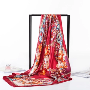 Elegant red silk square scarf featuring vintage floral and paisley patterns on a frame