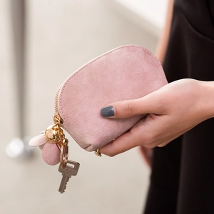 Pink faux suede dumpling coin purse with tassel keychain and metal zipper closure