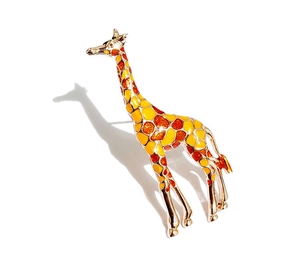Detail of a giraffe brooch with gold-plated metal and colorful enamel finish
