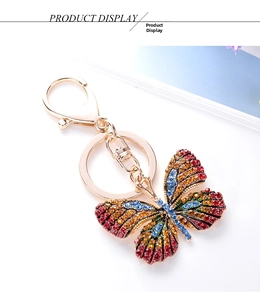 Close-up of butterfly keychain with colorful crystals and golden alloy lobster clasp