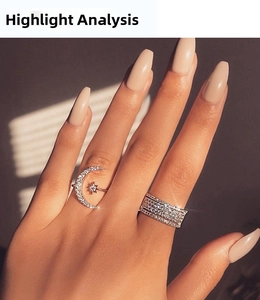 Close-up of model wearing silver crescent moon and multi-row zircon paved open rings