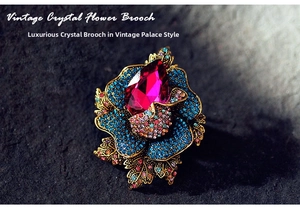 Macro view of vintage floral brooch with magenta crystal and colorful rhinestones