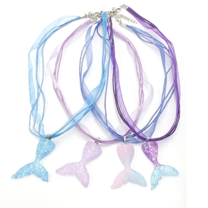 Detail of four gradient resin mermaid tail pendants with colorful ribbon necklaces
