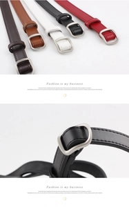 Detail of minimalist leather belts with sleek square metal buckles in five varied colors