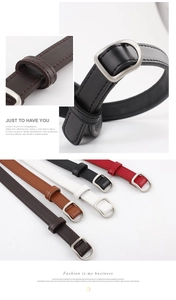 Close-up of slim leather belts with D-shape buckles in black, white, and brown colors