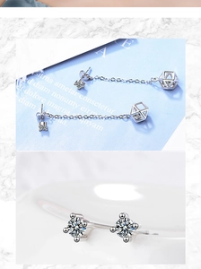 Close-up of geometric silver earrings with sparkling cubic zirconia crystals and long chains