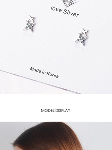 Detailed view of silver star earrings with pavé crystals including model wear shot