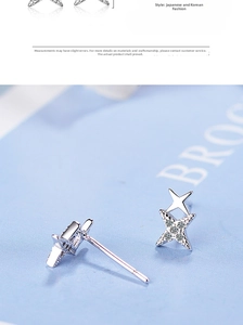 Detailed macro of silver star stud earrings with cubic zirconia and double-star design