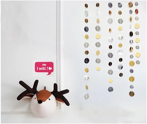 Close-up of gold and silver glitter circle garlands and star paper hanging decorations