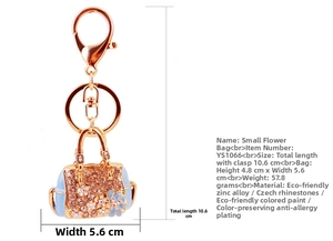 Detailed view of light blue handbag keychain with pink crystals and zinc alloy lobster clasp