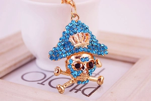 Macro shot of pirate skull keychain with blue crystals and a crown detail