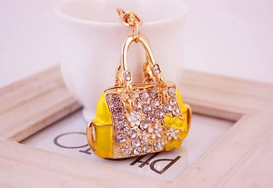 Close-up of yellow flower handbag keychain with sparkling rhinestones and gold clasp