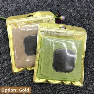 Macro view of gold self-sealing packaging bags with hanging hole on a textured surface