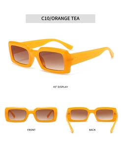 Detail view of orange tea rectangle sunglasses with thick frames and gradient lenses