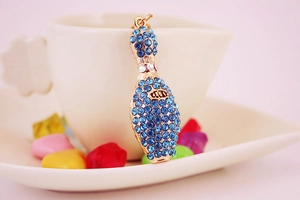 Detail of creative bowling bottle keychain pendant with sparkling blue rhinestones