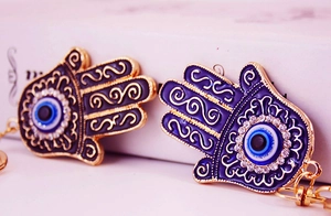 Detailed macro view of Hamsa Hand keychain with blue enamel and sparkling rhinestones