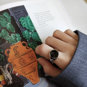 Detail of 925 sterling silver ring with black enamel inlay on person's hand
