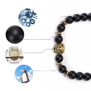 8mm matte black bead bracelet with golden lion head charm and decorative spacers