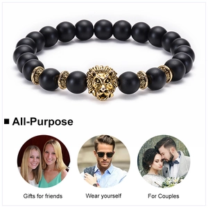 Detail view of 8mm matte black beaded bracelet featuring a gold alloy lion head charm