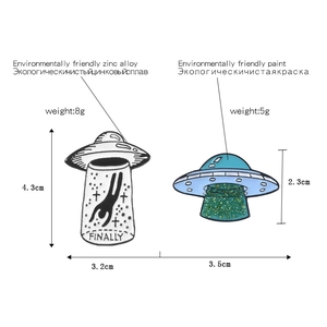 UFO spaceship enamel pins featuring 'FINALLY' text and green glitter details