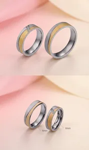 Detail of 6mm two-tone stainless steel couple rings with brushed finish and zircon inlay