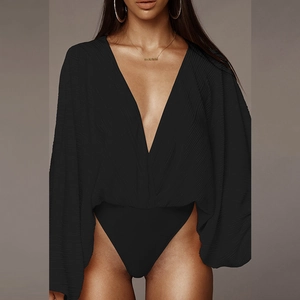 Detail of black long-sleeved bodysuit with deep V-neck and pleated fabric texture