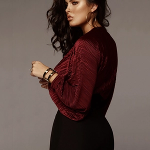 Detail showing the pleated texture and V-neck of this burgundy long sleeve jumpsuit