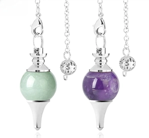 Detail of round amethyst and aventurine energy crystal pendants with silver metal cone bases