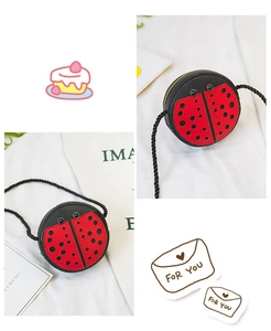 Detail view of ladybug-shaped kids crossbody bag with red polka dots and eyes