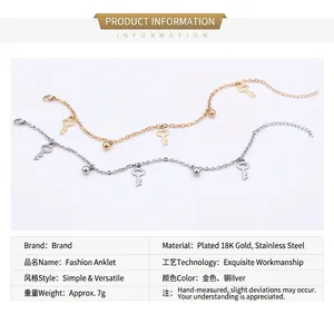Detail of 18K gold plated stainless steel key anklets in gold and silver finishes