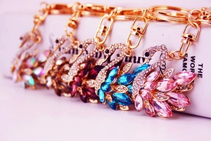 Macro shot of gold metal swan keychains with colorful crystal embellishments
