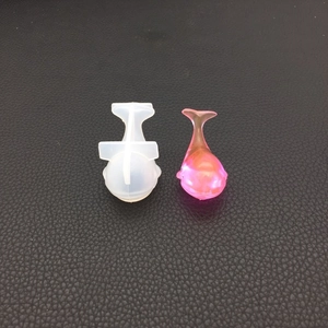 Macro view of translucent silicone whale mold and pink resin DIY craft creation