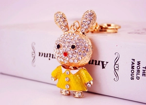 Close-up of golden bunny keychain with sparkling rhinestones and yellow enamel dress