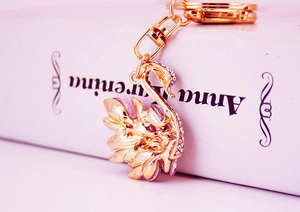 Close-up of golden swan keychain with pink crystals and clear rhinestones detail