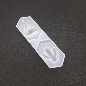 Detail of transparent silicone mold with flamingo and cactus shapes for DIY crafts