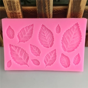 Pink silicone mold featuring multiple leaf and maple shapes for DIY fondant cake decoration