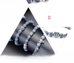 Macro detail of natural weathered agate beads with 8mm diameter and metal owl charms
