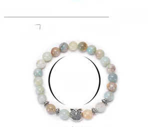 Detailed view of 8mm natural amazonite bead bracelet with vintage metal owl pendant