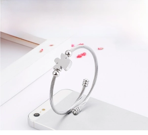 Detail view of silver stainless steel cable twisted bracelet with an angel-shaped charm