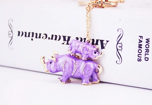 Detail of purple enamel rhino keychain with gold trim and sparkling rhinestone accents