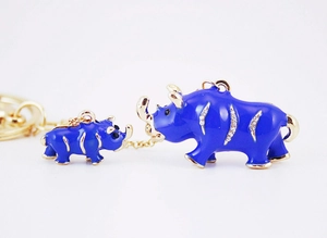 Detailed close-up of blue rhinestones and gold-plated mother and child rhino keychain