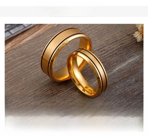 Detail of 18K gold plated stainless steel rings with black parallel groove accents