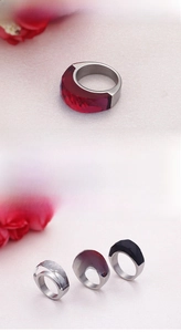 Polished stainless steel rings with faceted red, black, and clear resin stones