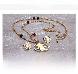 Detailed view of titanium steel necklace and earring set with girl silhouette pendants