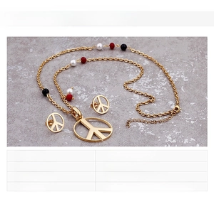 Detailed view of 18K gold plated peace sign jewelry set with colorful beads on steel